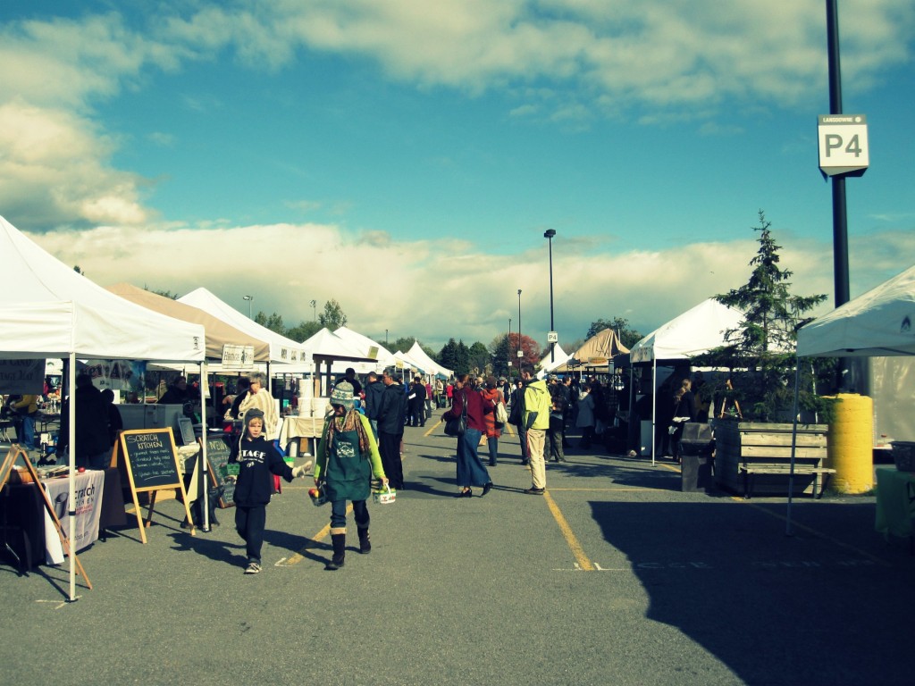 Visitors stroll through the market eyeing fresh produce.